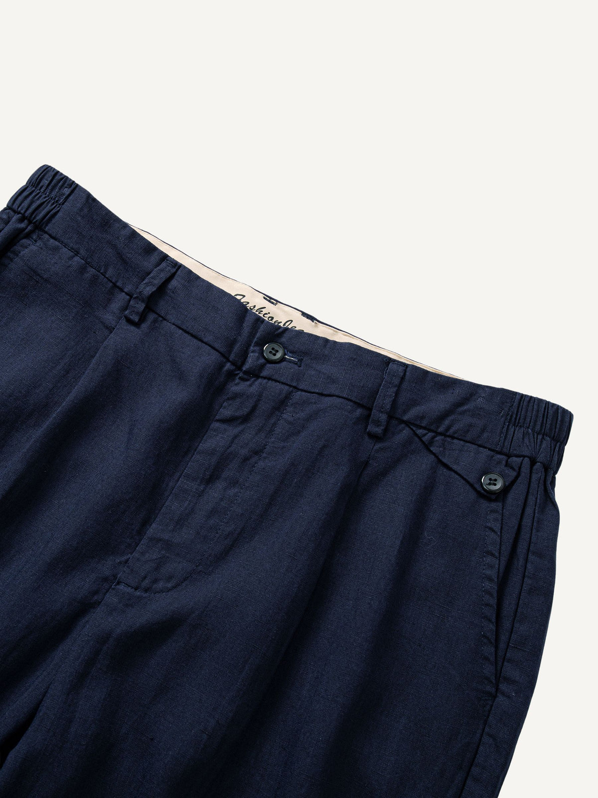 Waistband and double pleats detail of OROMEN Pleated Linen Trousers in Navy