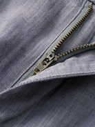 Zipper fly and button closure detail of OROMEN Pleated Relaxed Fit Linen Trousers