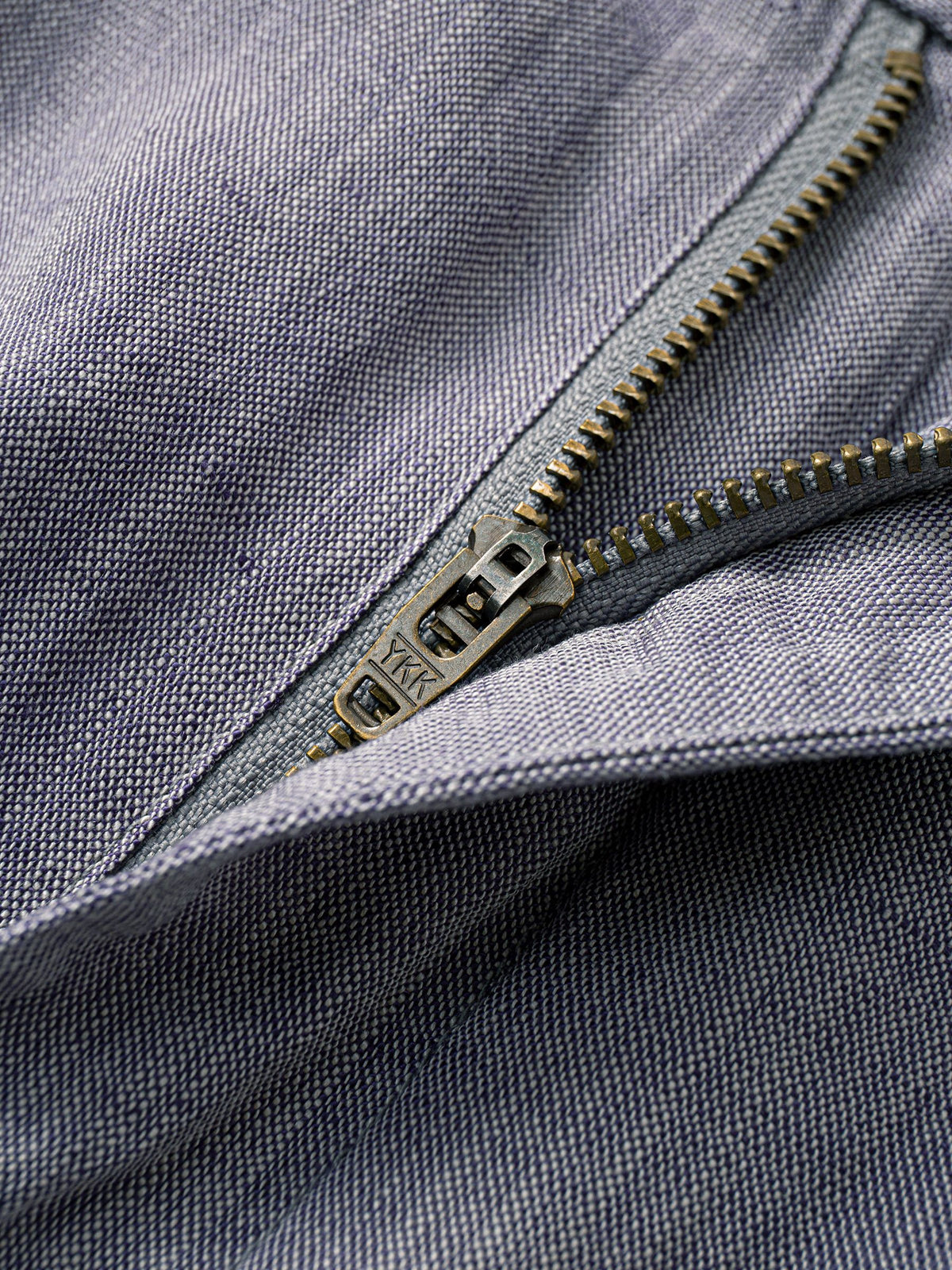 Zipper fly and button closure detail of OROMEN Pleated Relaxed Fit Linen Trousers